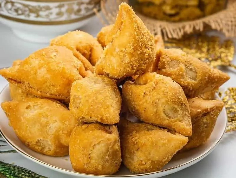 Crispy veg samosas served on a plate at Lovely Sweets Calgary